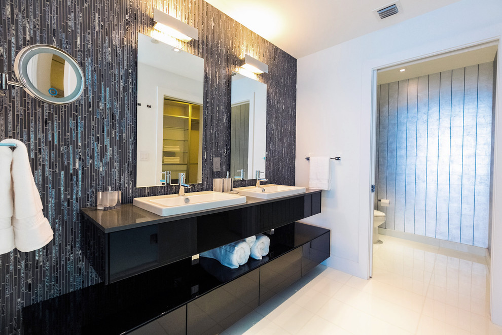 Mid-sized modern master bathroom in Miami with flat-panel cabinets, black cabinets, mosaic tile, blue tile, gray tile, green tile, multi-coloured walls, porcelain floors, a drop-in sink and solid surface benchtops.