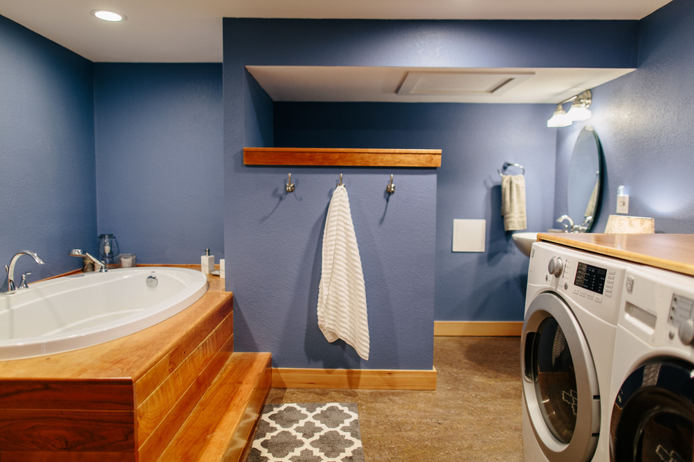 Example of a transitional beige floor bathroom/laundry room design in Seattle with blue walls and a pedestal sink