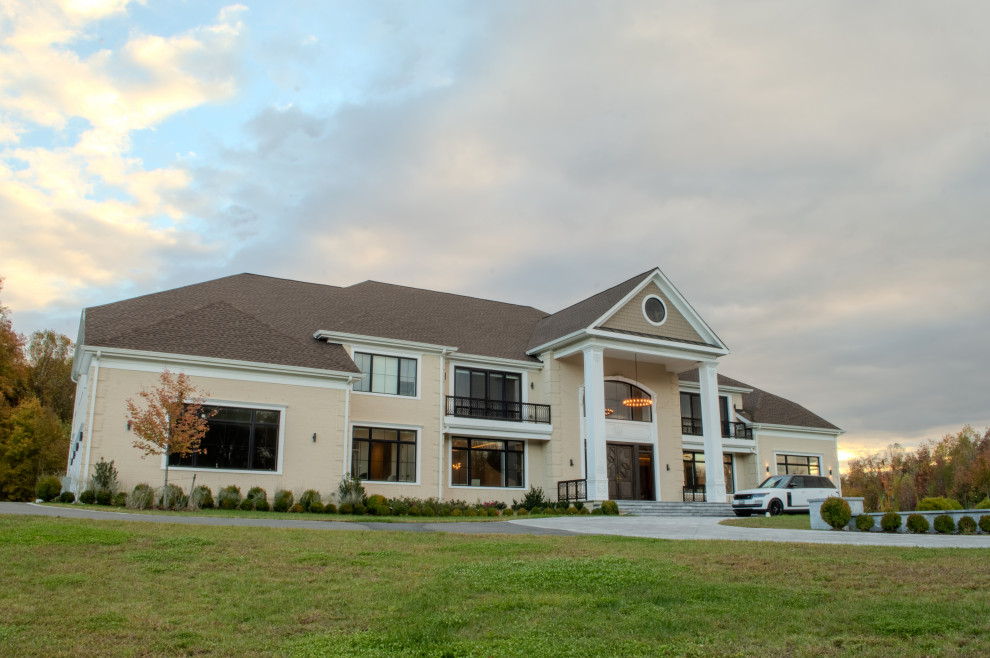 Inspiration for a huge transitional beige flat roof remodel with a brown roof