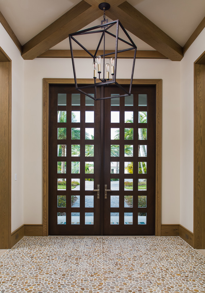 This is an example of an expansive transitional front door in Orlando with beige walls, a double front door and a dark wood front door.