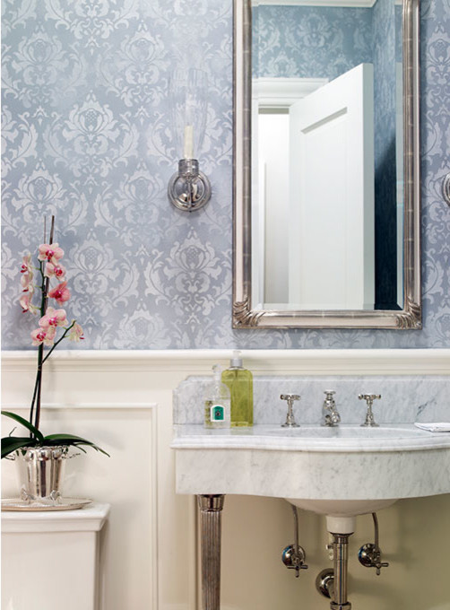Mid-sized traditional powder room in Other with blue walls, an integrated sink and gray tile.