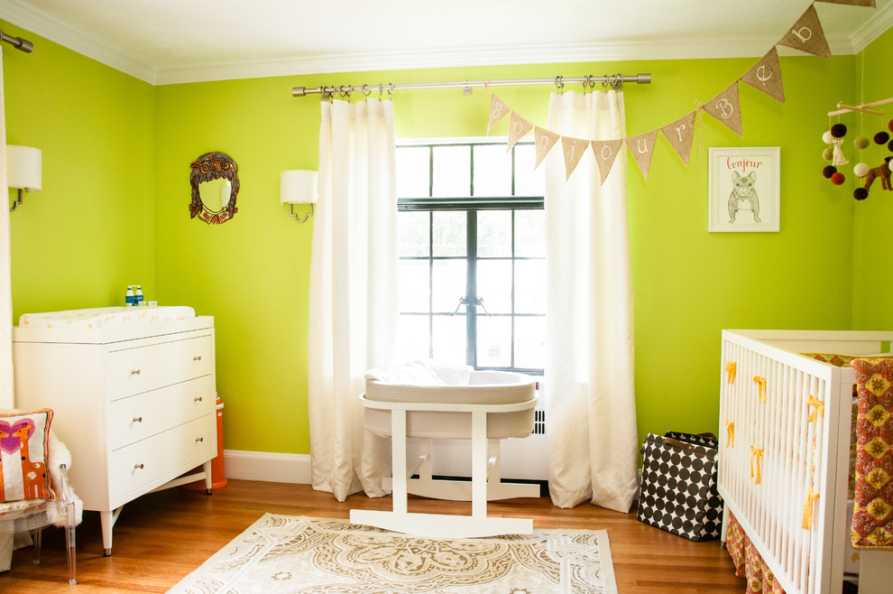 Design ideas for a contemporary gender-neutral nursery in Boston with green walls, medium hardwood floors and orange floor.