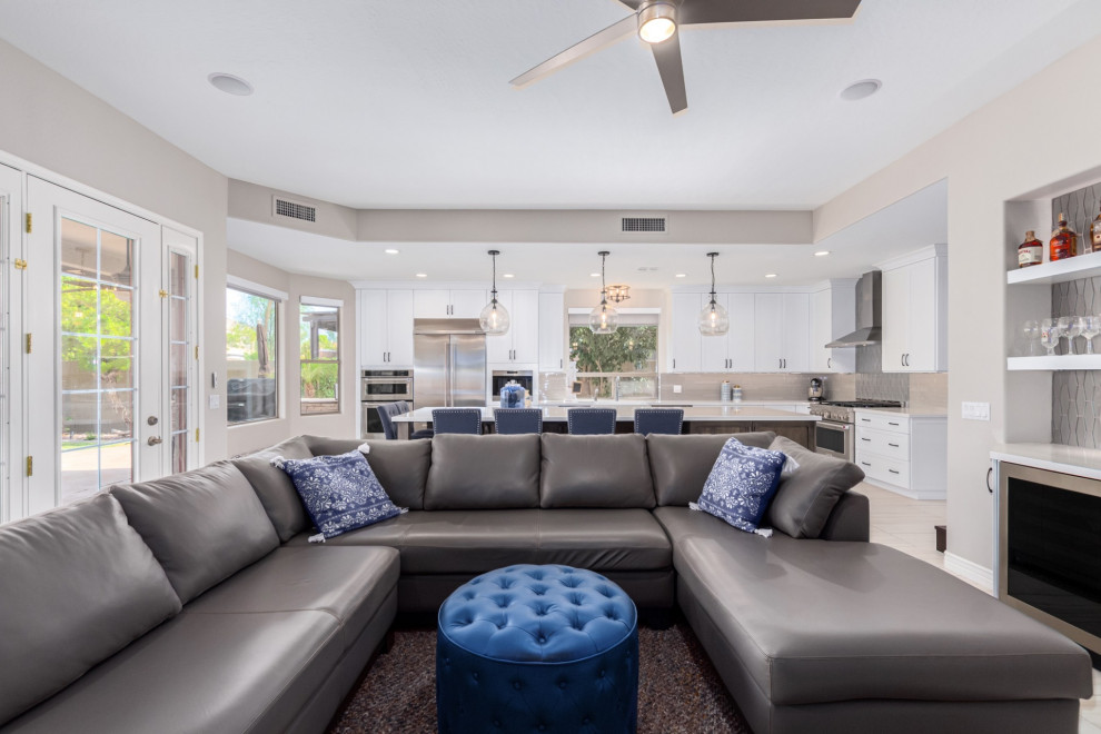 Kitchen - transitional kitchen idea in Phoenix with a farmhouse sink, shaker cabinets, white cabinets, gray backsplash, stainless steel appliances and white countertops