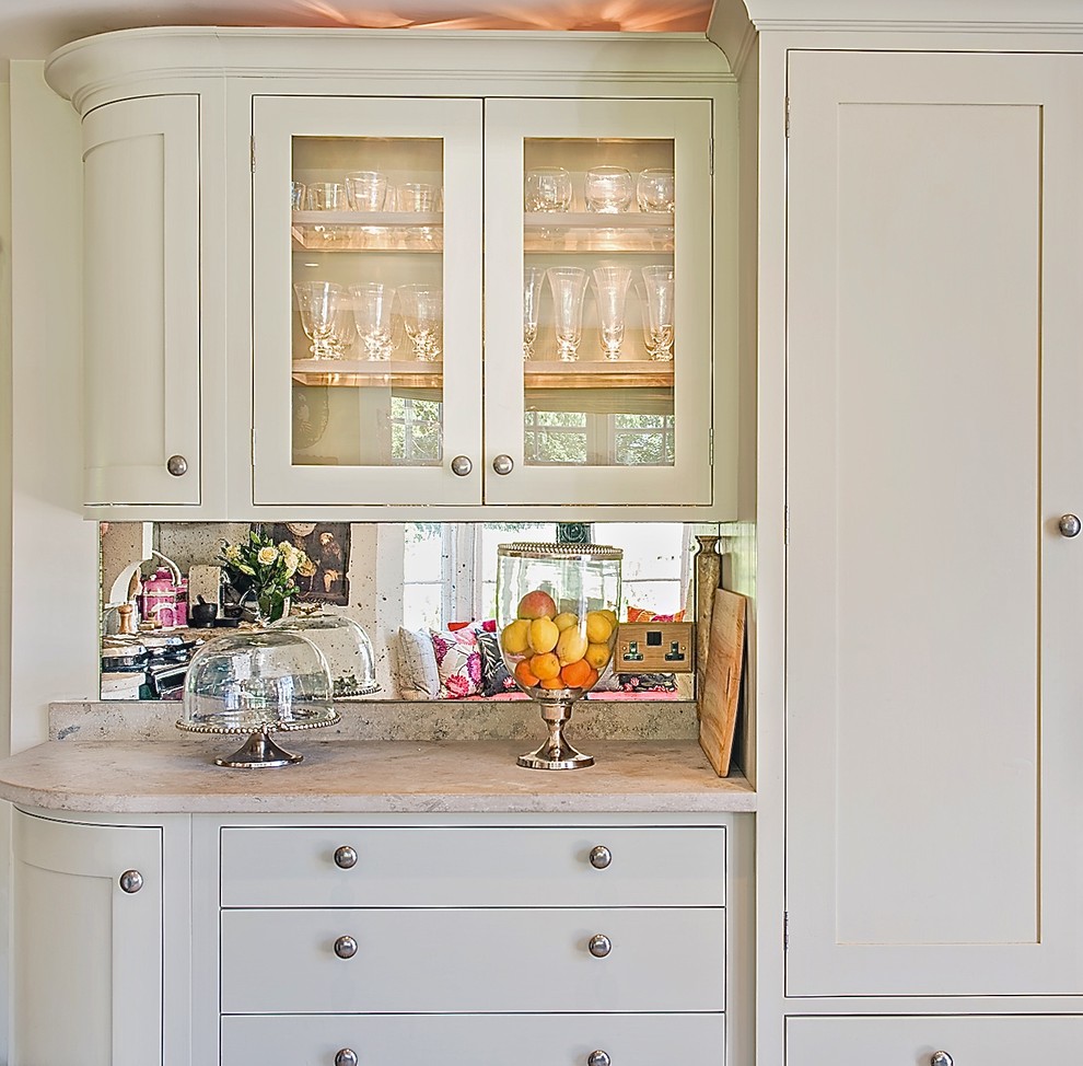 Inspiration for a mid-sized traditional u-shaped eat-in kitchen in Berkshire with a farmhouse sink, shaker cabinets, grey cabinets, limestone benchtops, metallic splashback, mirror splashback, porcelain floors and no island.