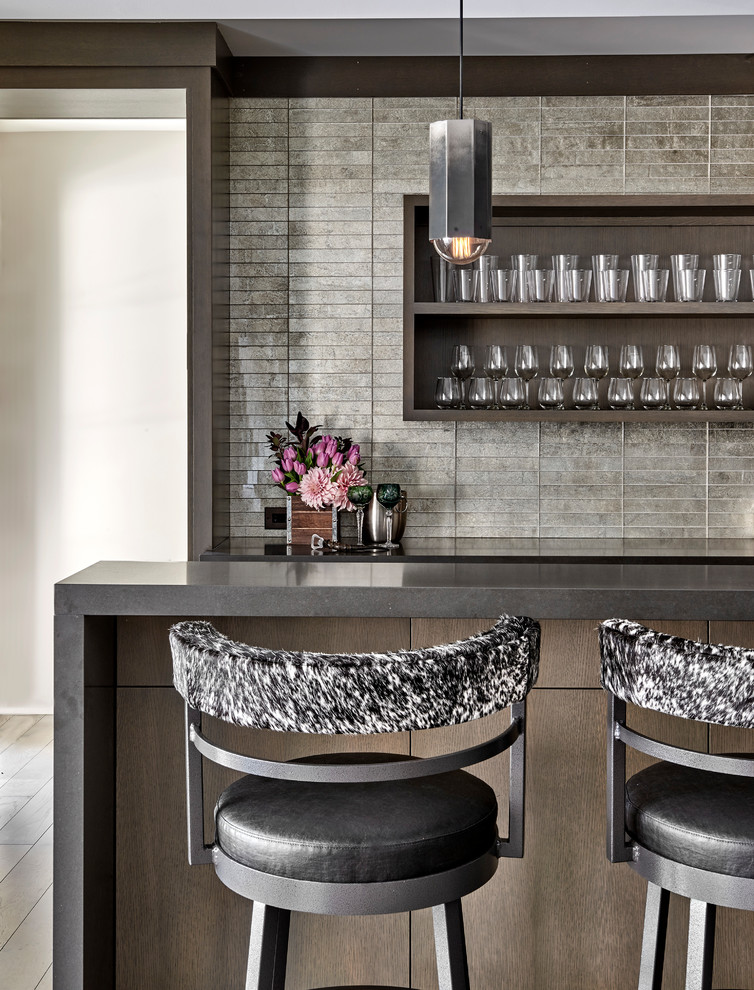 Inspiration for a contemporary home bar in Chicago with grey benchtop.