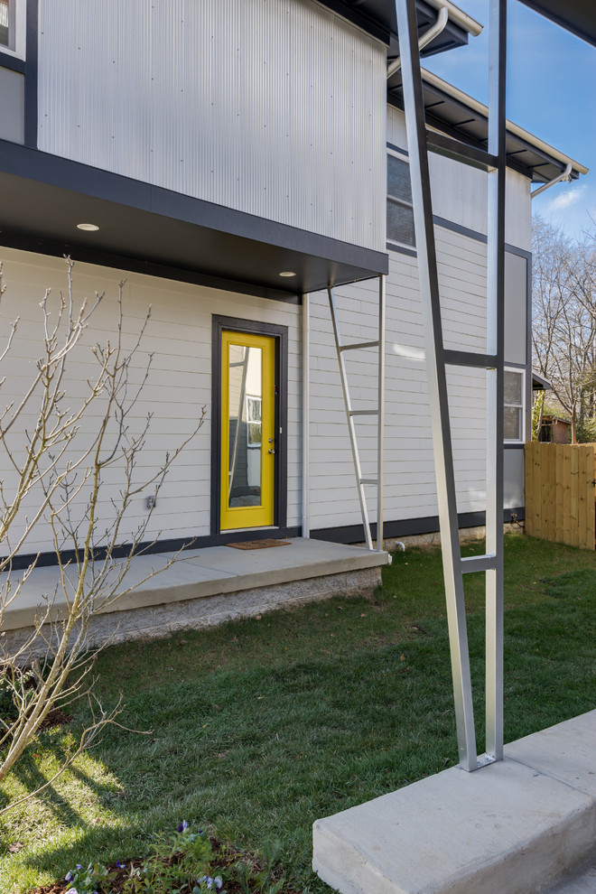 This is an example of a contemporary grey exterior in Nashville with mixed siding.