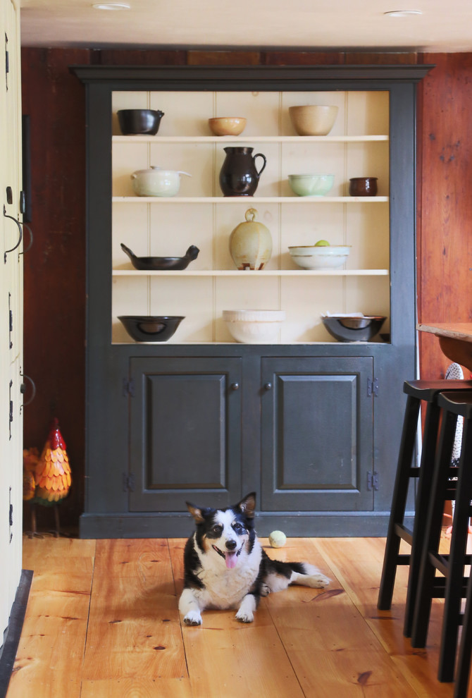 Inspiration for a mid-sized country kitchen pantry in Boston with an undermount sink, beaded inset cabinets, black cabinets, wood benchtops, white splashback, light hardwood floors, with island, stone tile splashback and panelled appliances.