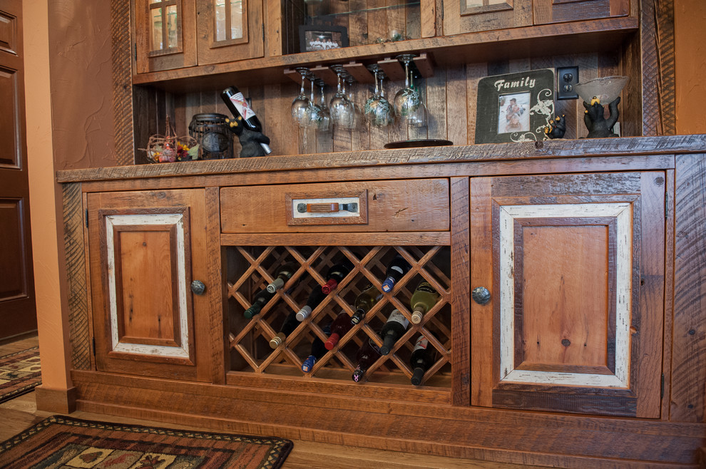 Mountain style u-shaped eat-in kitchen photo with an undermount sink, raised-panel cabinets, granite countertops and stainless steel appliances