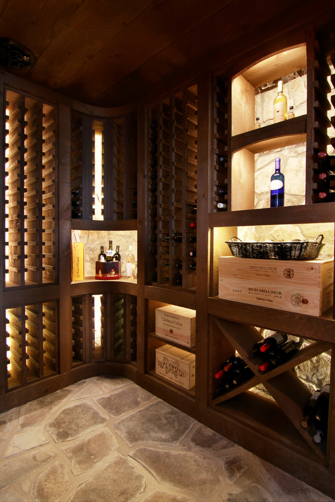Photo of a mid-sized country wine cellar in Toronto with slate floors and storage racks.