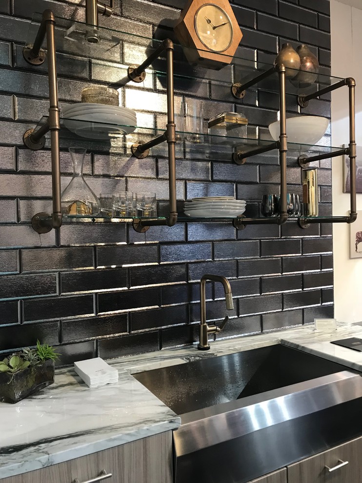 Design ideas for a mid-sized industrial single-wall separate kitchen in Other with flat-panel cabinets, light wood cabinets, marble benchtops, black splashback, brick splashback, stainless steel appliances, no island, white benchtop and a farmhouse sink.