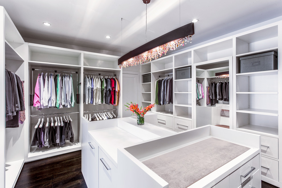 Design ideas for a large contemporary gender-neutral walk-in wardrobe in New York with flat-panel cabinets, white cabinets and dark hardwood floors.
