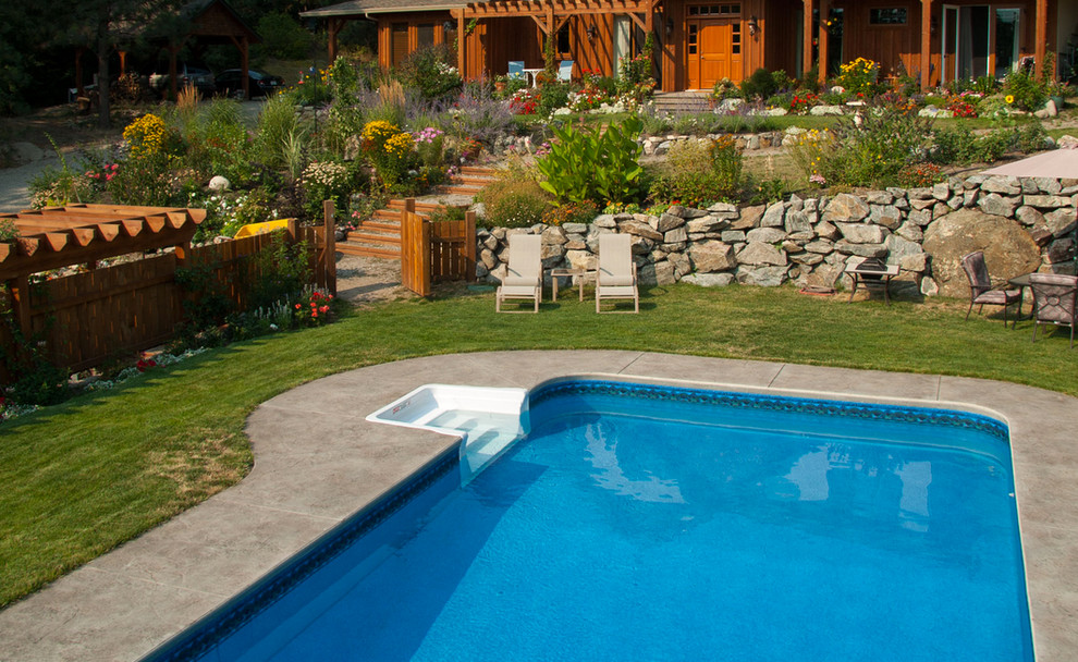 Example of a large backyard custom-shaped pool design in Vancouver