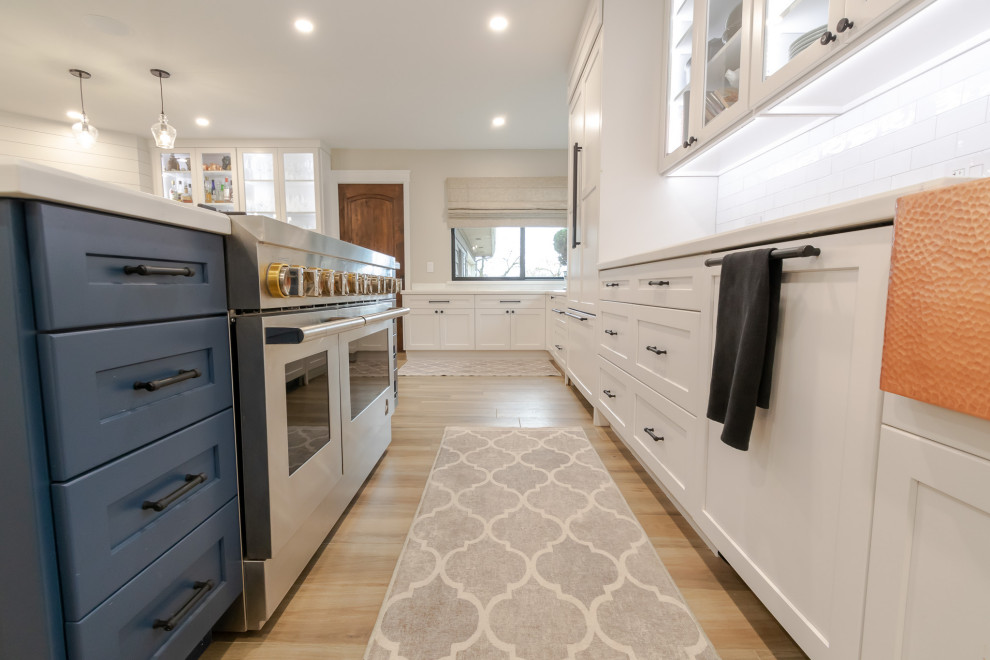 Open concept kitchen - huge rustic l-shaped open concept kitchen idea in San Francisco with an undermount sink, shaker cabinets, white backsplash, ceramic backsplash, stainless steel appliances and an island