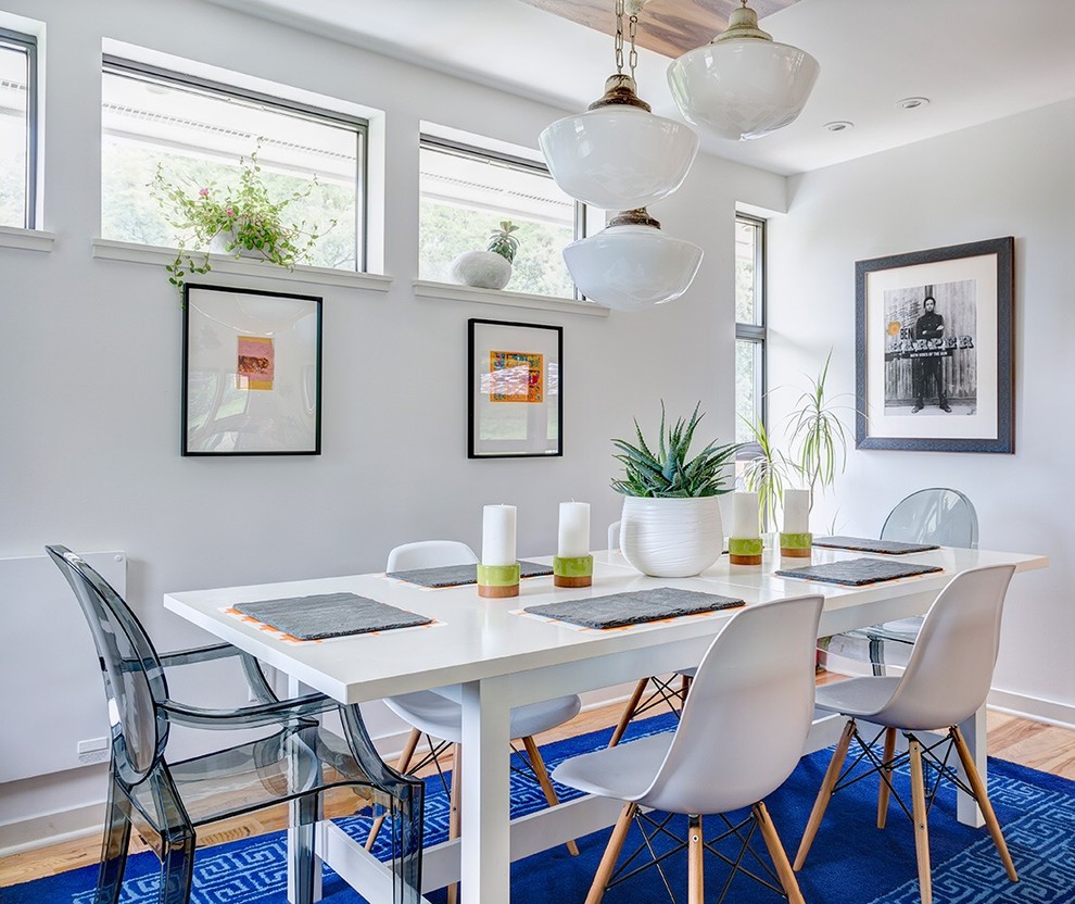 Trendy light wood floor dining room photo in Kansas City with white walls