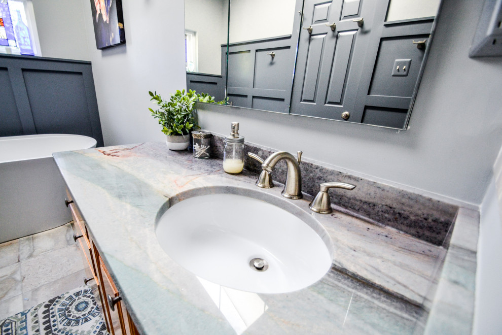 Small traditional master bathroom in DC Metro with raised-panel cabinets, light wood cabinets, a japanese tub, a corner shower, grey walls, ceramic floors, an undermount sink, granite benchtops, grey floor, a hinged shower door, grey benchtops, a single vanity and a floating vanity.