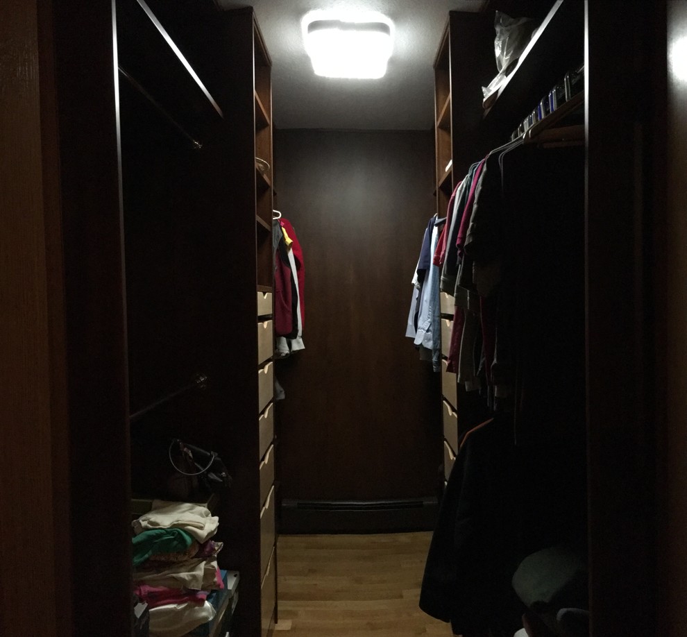 Walk-in closet - mid-sized transitional light wood floor walk-in closet idea with open cabinets and dark wood cabinets