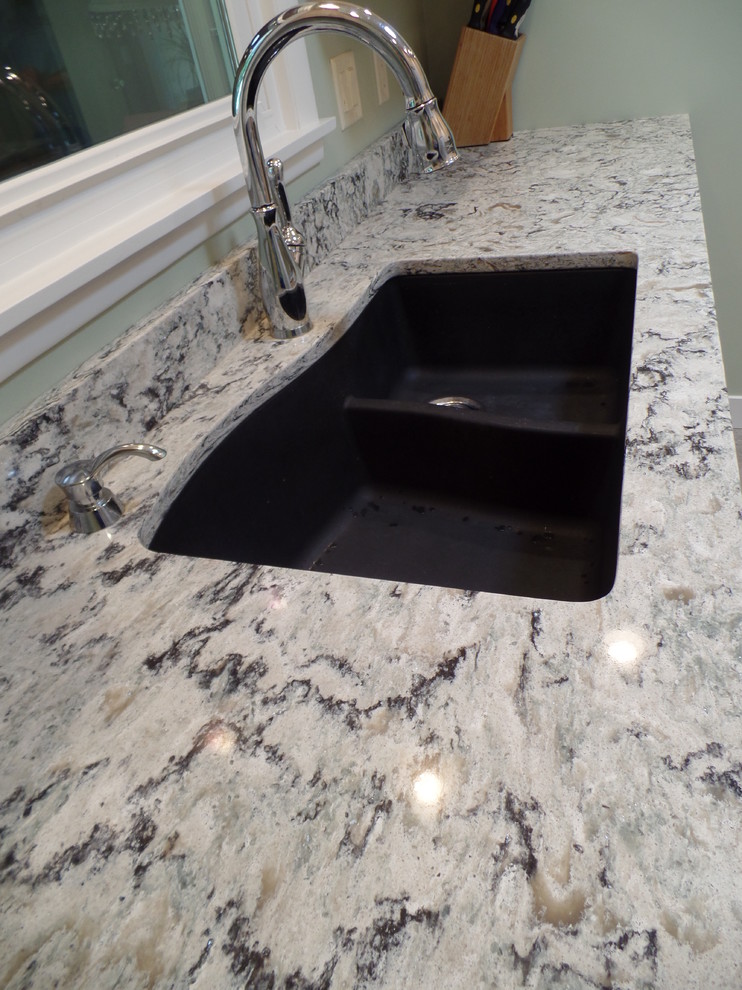 Home design - mid-sized transitional galley vinyl floor home design idea in Cedar Rapids with an undermount sink, shaker cabinets, light wood cabinets, quartz countertops, white appliances and no island