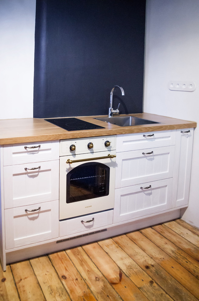 Small mountain style single-wall kitchen photo with recessed-panel cabinets