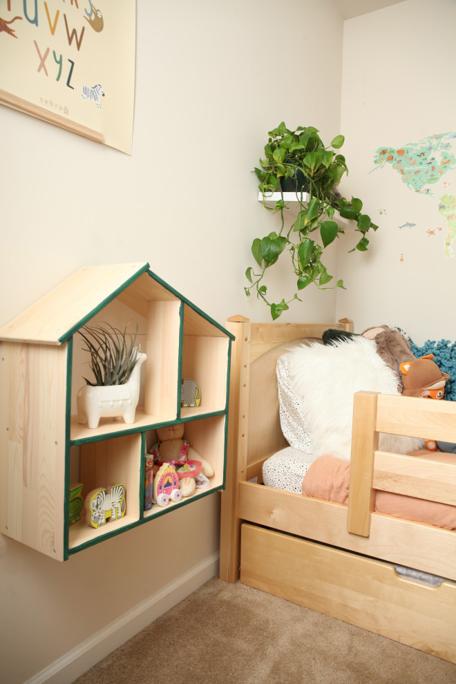 Photo of a small contemporary gender-neutral kids' room in Other with green walls.