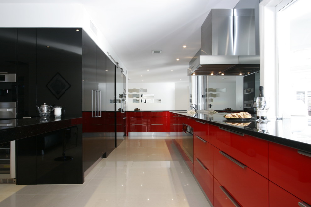 Modern galley kitchen in Brisbane with flat-panel cabinets and red cabinets.