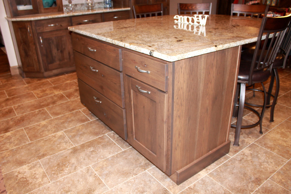 Eat-in kitchen - large rustic l-shaped eat-in kitchen idea in Chicago with a farmhouse sink, shaker cabinets, dark wood cabinets, granite countertops, stainless steel appliances and an island