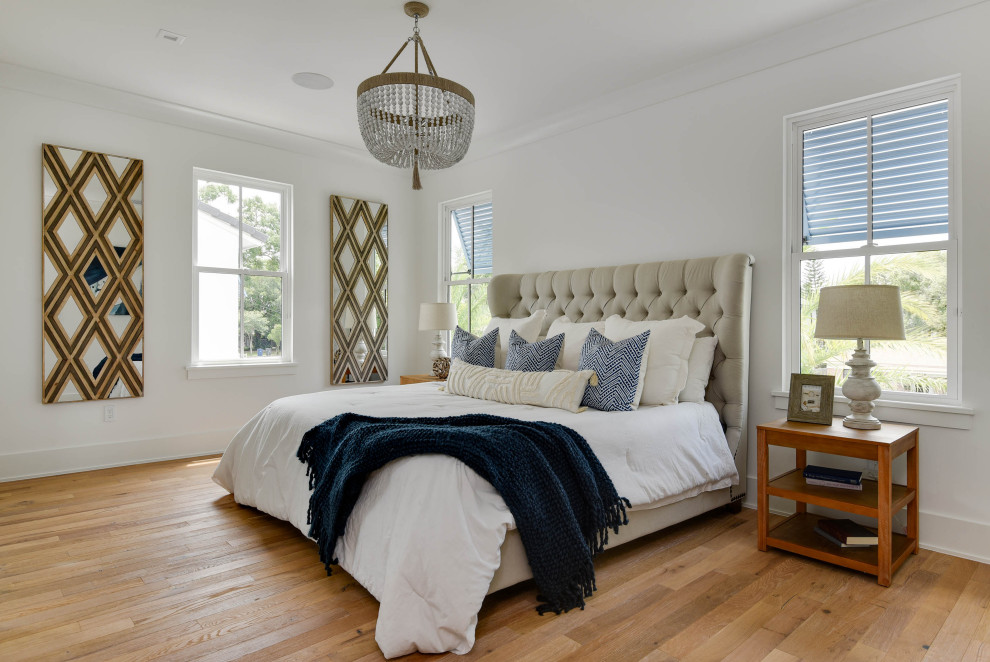 Large transitional master bedroom in Orlando with white walls, light hardwood floors and beige floor.