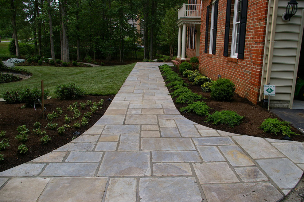 Inspiration for a large tropical rooftop full sun formal garden for spring in Newark with natural stone pavers.