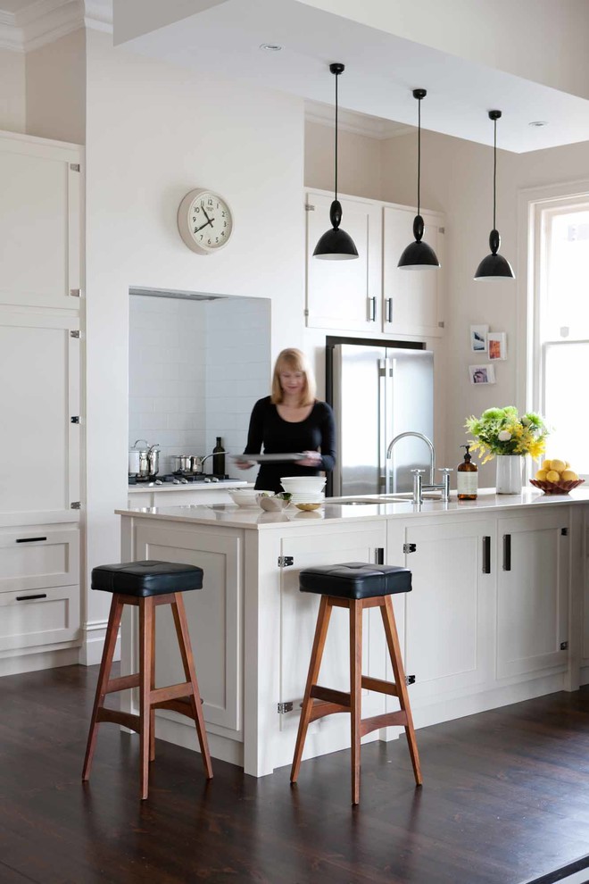 Inspiration for a traditional galley open plan kitchen in Adelaide with shaker cabinets, white cabinets, white splashback, subway tile splashback, stainless steel appliances, dark hardwood floors and with island.