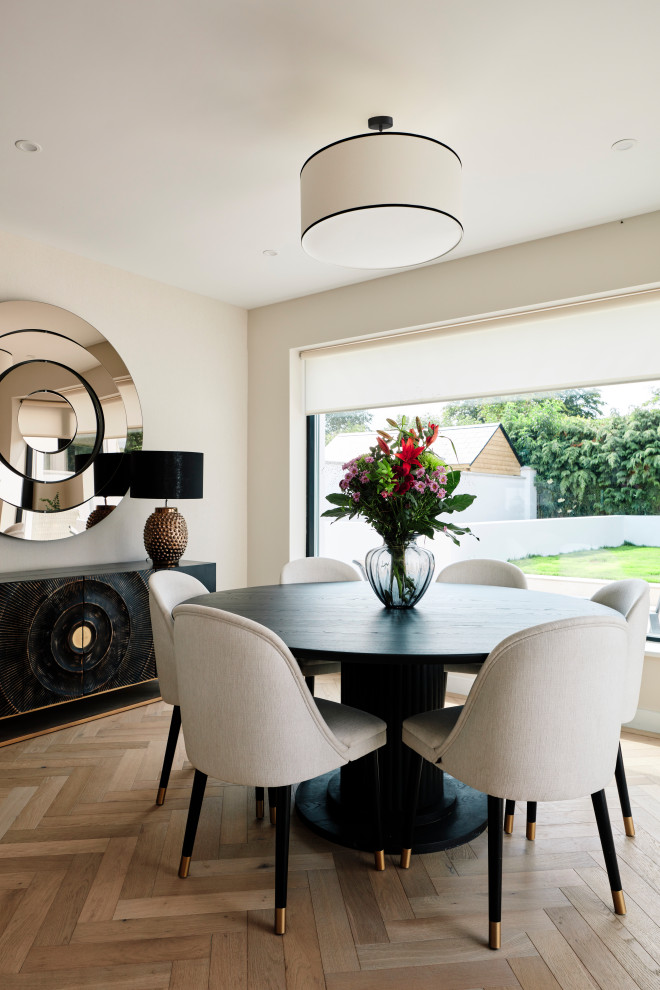 Large contemporary dining room in Other with white walls, laminate floors and beige floor.