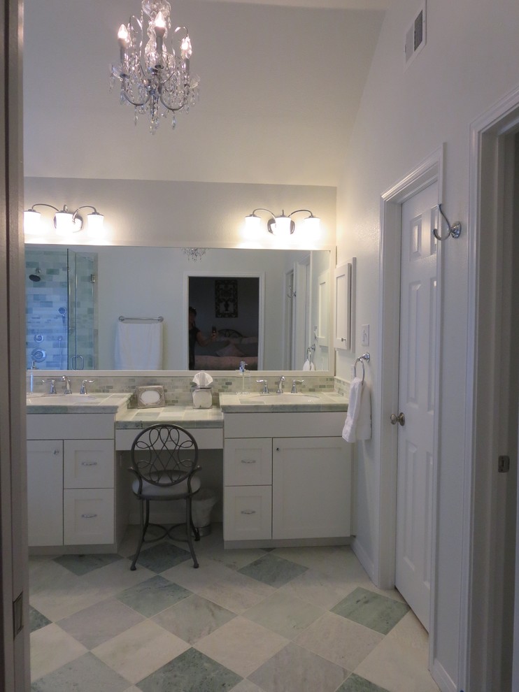 Mid-sized transitional master green tile and marble tile marble floor and green floor drop-in bathtub photo in Austin with shaker cabinets, white cabinets, a one-piece toilet, green walls, an undermount sink, marble countertops and a hinged shower door
