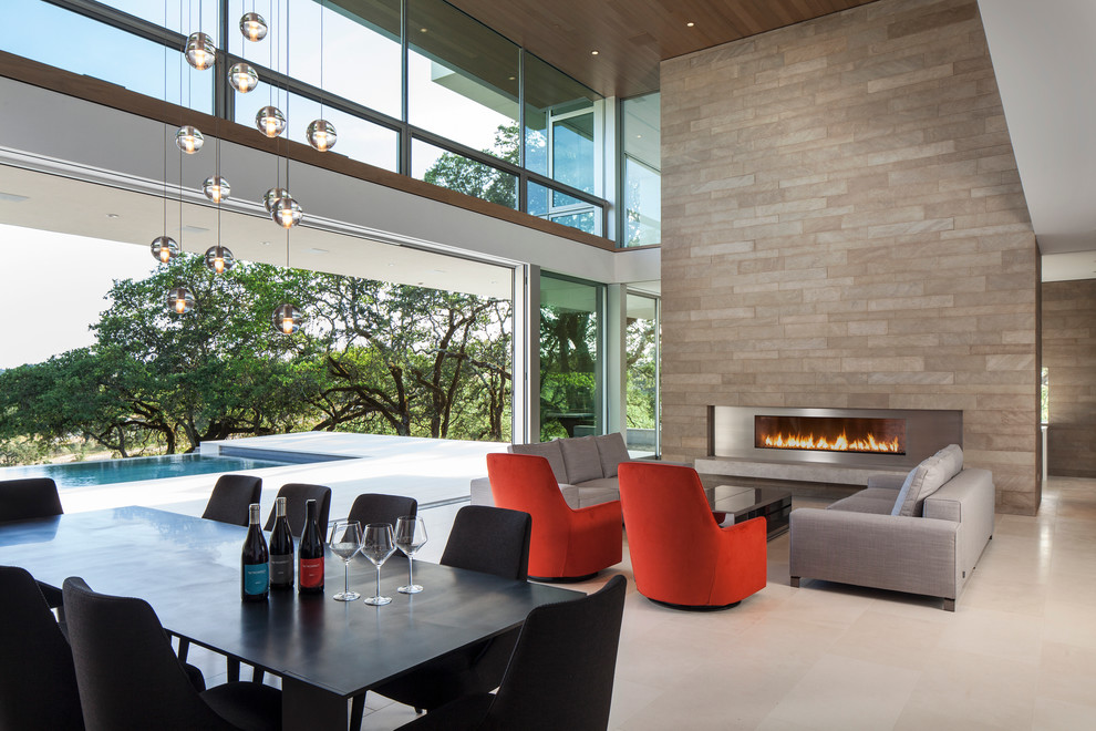 Mid-sized contemporary formal open concept living room in San Francisco with white walls, limestone floors and a ribbon fireplace.