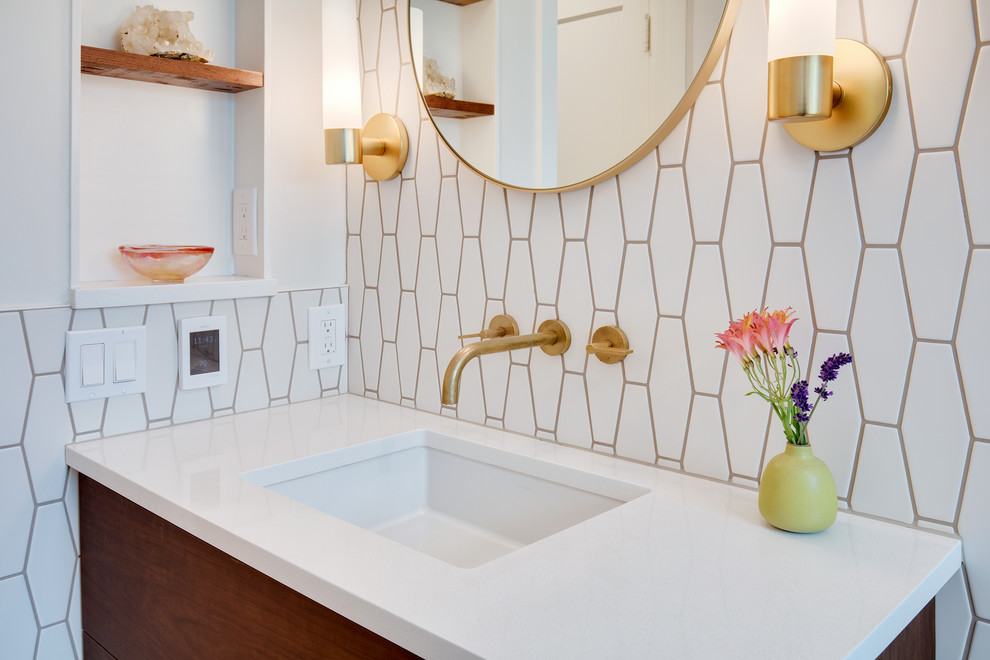 Inspiration for a mid-sized modern bathroom in Seattle with flat-panel cabinets, medium wood cabinets, a drop-in tub, a shower/bathtub combo, a one-piece toilet, white tile, cement tile, white walls, ceramic floors, a drop-in sink, quartzite benchtops, a shower curtain and white benchtops.