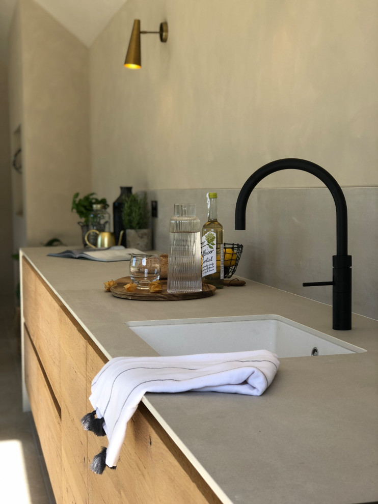 This is an example of a contemporary kitchen in Other with light wood cabinets, white splashback, porcelain splashback, yellow benchtop and white floor.