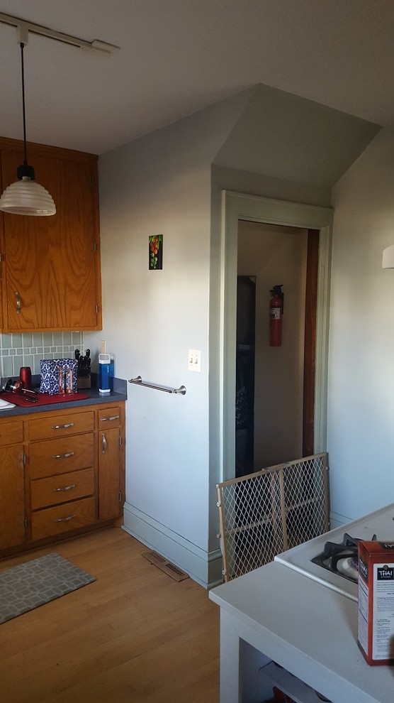Enclosed kitchen - small light wood floor enclosed kitchen idea with a double-bowl sink, flat-panel cabinets, wood countertops, gray backsplash, ceramic backsplash, white appliances and no island