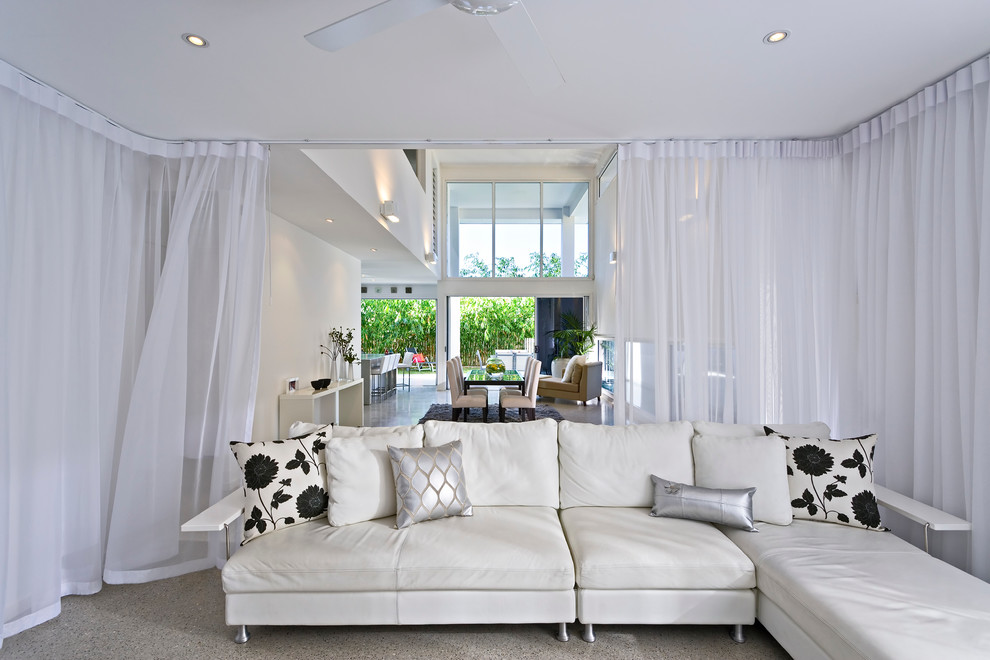 Contemporary open concept living room in Brisbane with white walls.