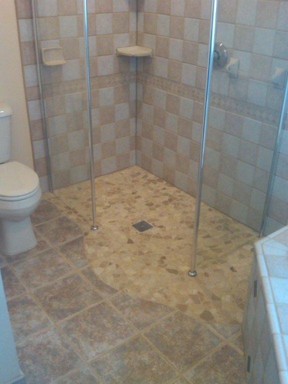 Mid-sized modern 3/4 bathroom in Denver with a corner tub, a curbless shower, a two-piece toilet, white tile, marble, beige walls, mosaic tile floors, grey floor and a hinged shower door.