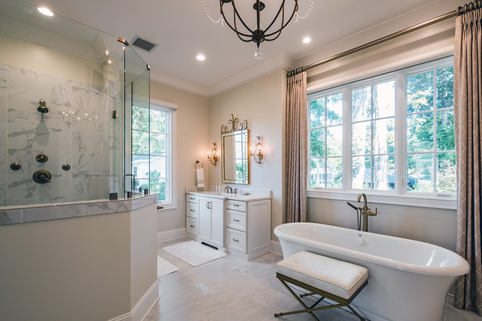 Large transitional master bathroom in Other with shaker cabinets, white cabinets, a freestanding tub, an alcove shower, beige walls, porcelain floors, an undermount sink, quartzite benchtops, grey floor, gray tile, white tile and marble.