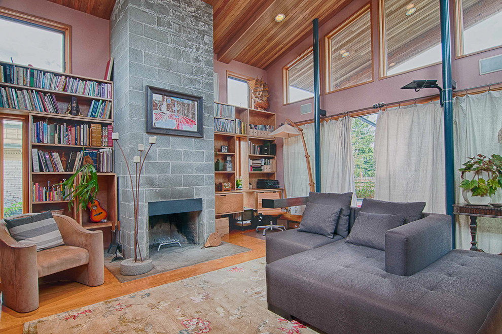 Inspiration for an eclectic living room in Portland with a library and a standard fireplace.