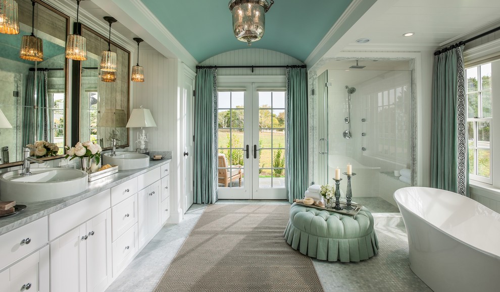 This is an example of a large traditional master bathroom in Miami with white cabinets, a freestanding tub, a corner shower, mosaic tile floors, a vessel sink, marble benchtops, multi-coloured tile, mosaic tile and white walls.