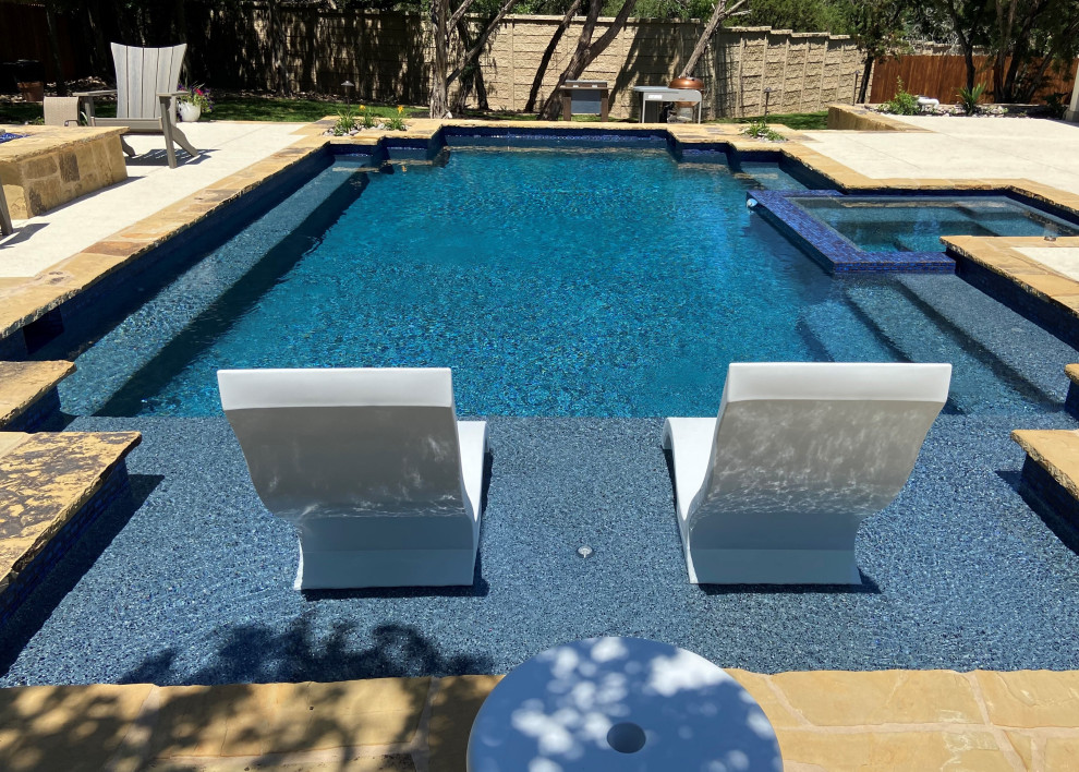 This is an example of a large contemporary custom-shaped pool in Other with decking.