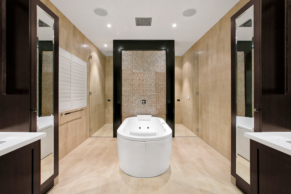 Photo of a transitional master bathroom in Melbourne with shaker cabinets, dark wood cabinets, a hot tub, an alcove shower, beige tile and a hinged shower door.