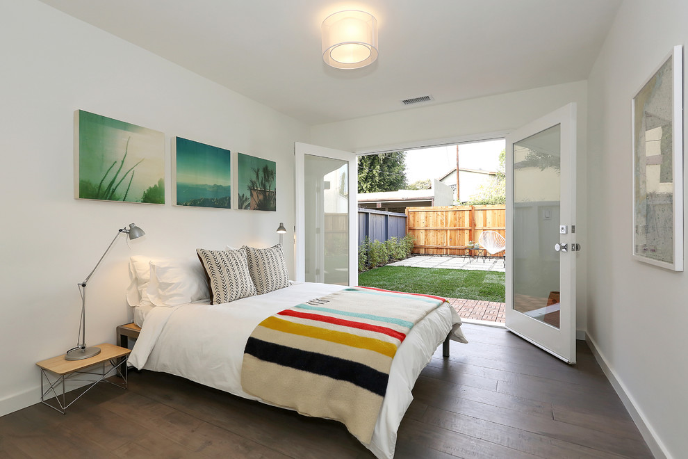 Inspiration for a contemporary bedroom in Los Angeles with white walls and dark hardwood floors.