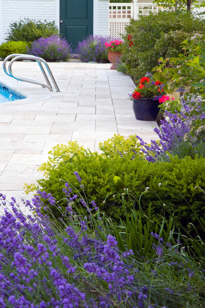 Inspiration for a large mediterranean backyard garden in Chicago with a water feature and natural stone pavers.