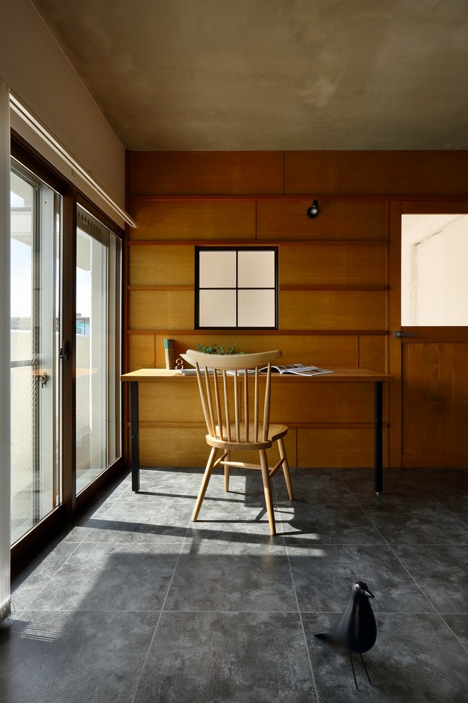 This is an example of a mid-sized midcentury home office in Kyoto with white walls, ceramic floors and grey floor.
