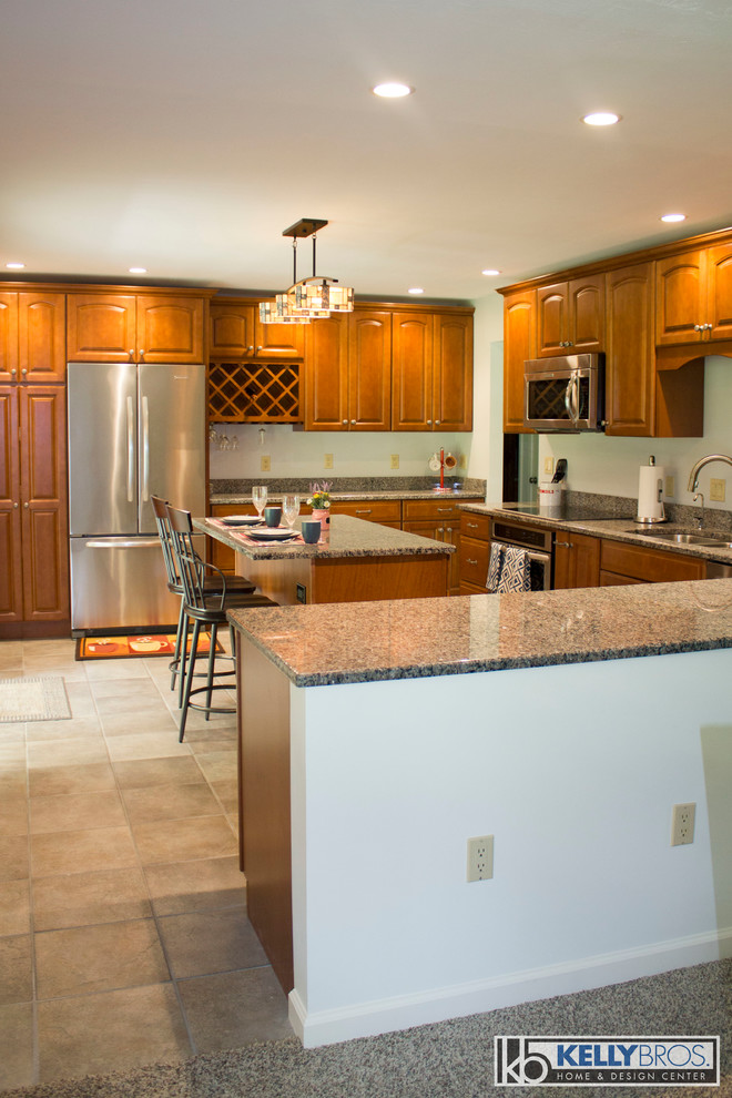 Eat-in kitchen - large transitional u-shaped ceramic tile eat-in kitchen idea in Cincinnati with a double-bowl sink, raised-panel cabinets, medium tone wood cabinets, granite countertops, stainless steel appliances and an island