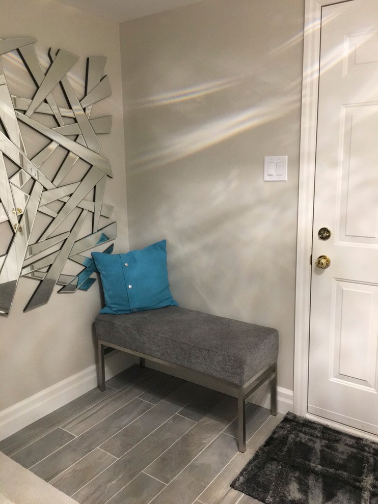 Small transitional dark wood floor foyer photo in Toronto with gray walls