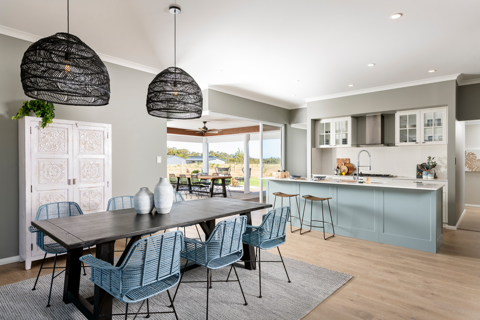This is an example of a kitchen/dining combo in Perth with grey walls, light hardwood floors and beige floor.
