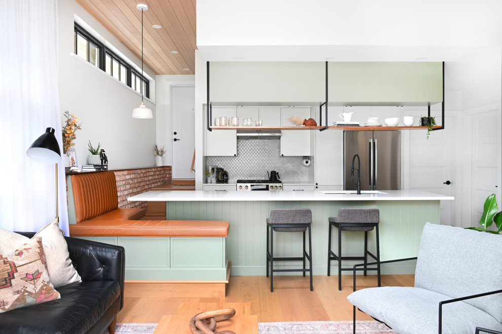 Inspiration for a small transitional galley eat-in kitchen in Vancouver with an undermount sink, shaker cabinets, green cabinets, quartz benchtops, grey splashback, ceramic splashback, stainless steel appliances, light hardwood floors, with island, beige floor, white benchtop and wood.