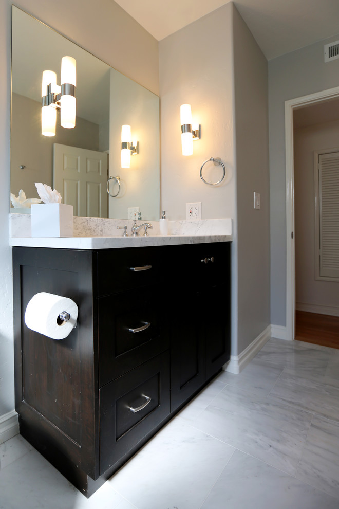Inspiration for a large traditional kids bathroom in San Diego with shaker cabinets, black cabinets, marble benchtops, blue tile, stone tile, an alcove tub, a shower/bathtub combo, a two-piece toilet, an undermount sink, white walls and marble floors.