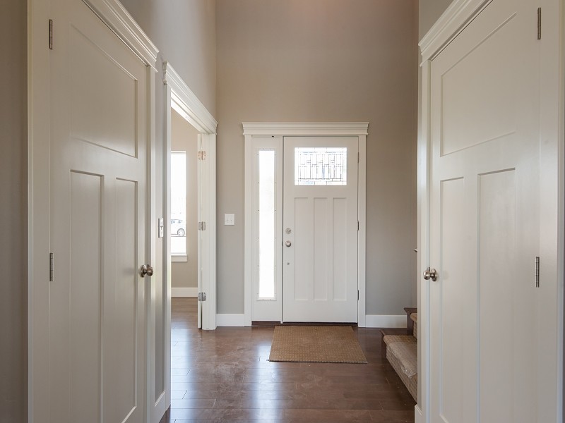 This is an example of a mid-sized arts and crafts front door in Salt Lake City with grey walls, medium hardwood floors, a single front door and a white front door.